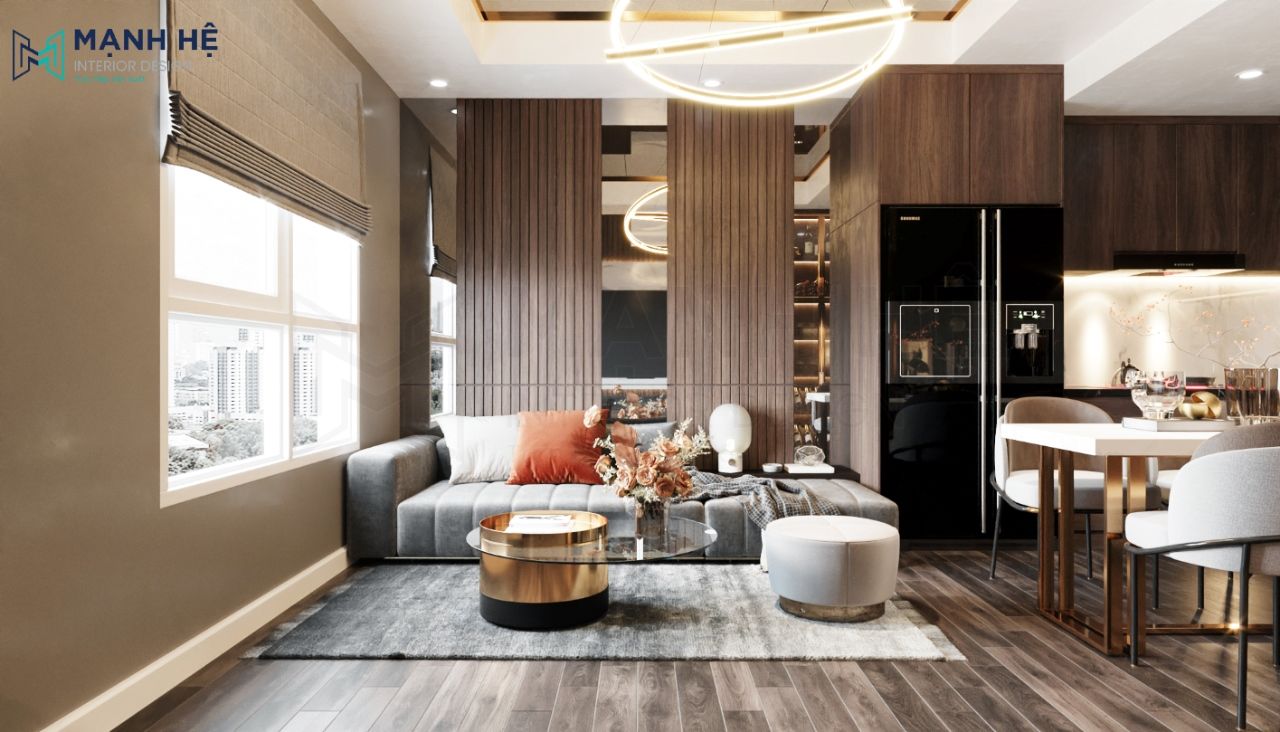 Phòng khách liền bếp đặt bộ sofa nhung kết hợp với bàn trà tròn làm nổi bật lên nét sang trọng của tổng thể