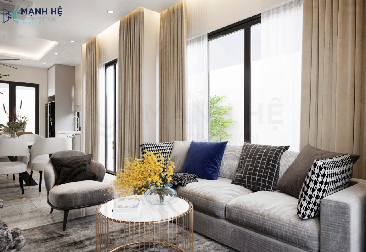 Bàn trà tròn mặt đá kết hợp cùng bộ sofa xám tinh tế tạo điểm nhấn cho căn phòng khách liền bếp