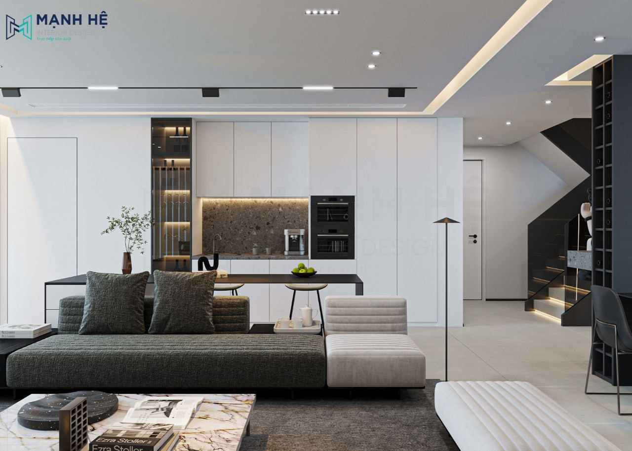 Hệ tủ bếp chữ I đặt song song với ghế sofa và bàn đảo bếp