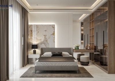 Phòng ngủ matser với giường bọc nệm xám kết hợp vách đầu giường được ốp đá kết hợp đèn hắt
